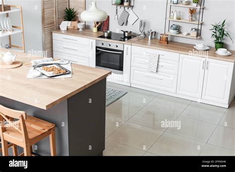 Table in stylish interior of modern kitchen Stock Photo - Alamy