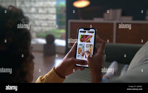 Hand closeup browsing food online store on cellphone app. Person ...