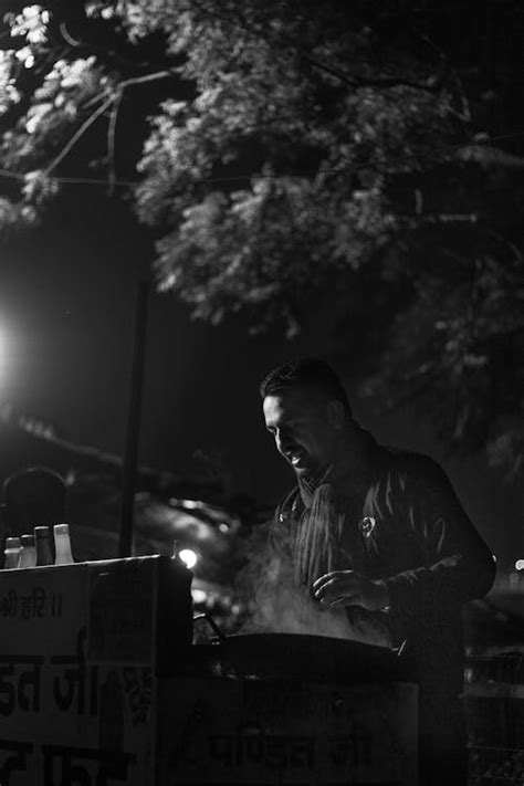 Man Preparing Street Food at a Food Market Night · Free Stock Photo