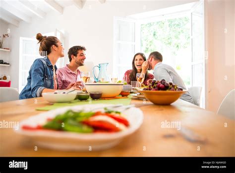 Friends dining together Stock Photo - Alamy