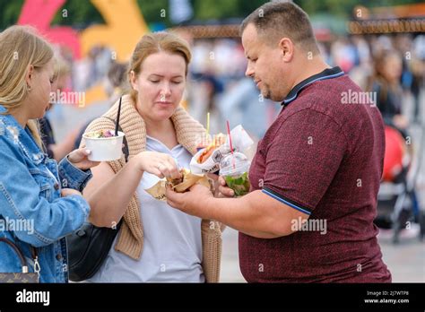 People eating street food during event Stock Photo - Alamy
