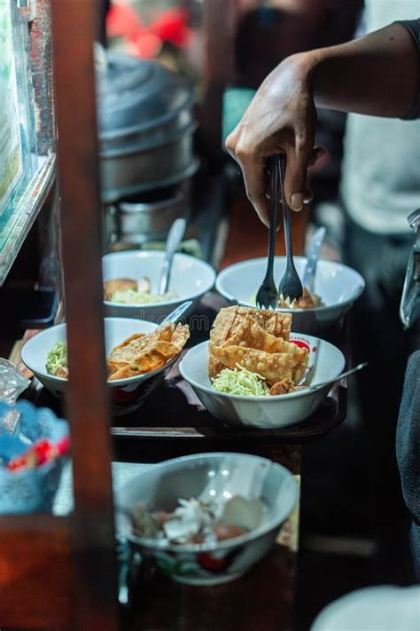 Street Food Vendor Preparing Chicken Noodles with Fried Wontons Stock ...