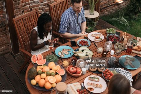 Happy Friends Eating Outdoors And Having Fun High-Res Stock Photo ...