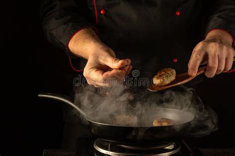 In a Dimly Lit Kitchen, a Skilled Chef Crafts Delicious Meatballs ...