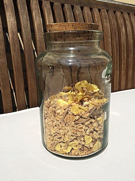 Premium Photo | Close-up of dry herbs in jar on table