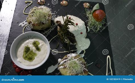 Presentation of Exotic Dish with White Sauce and Roast in an Expensive ...