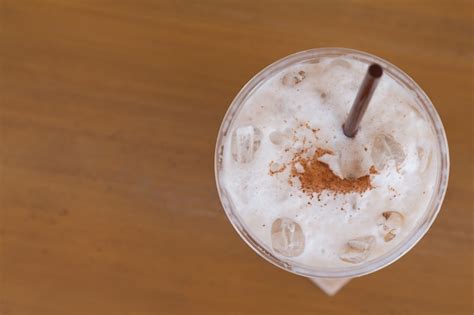 Premium Photo | Close up of iced coffee with straw