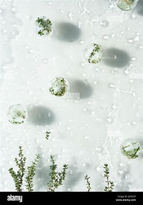 Wet off white water background with melting balls of ice with frozen ...