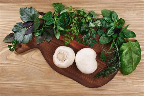 Premium Photo | Fresh herbs on wooden cutboard