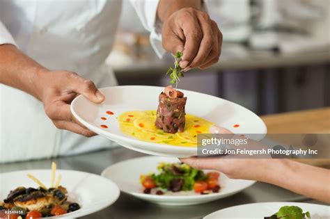 Chef Putting Garnish On Plate Of Food High-Res Stock Photo - Getty Images