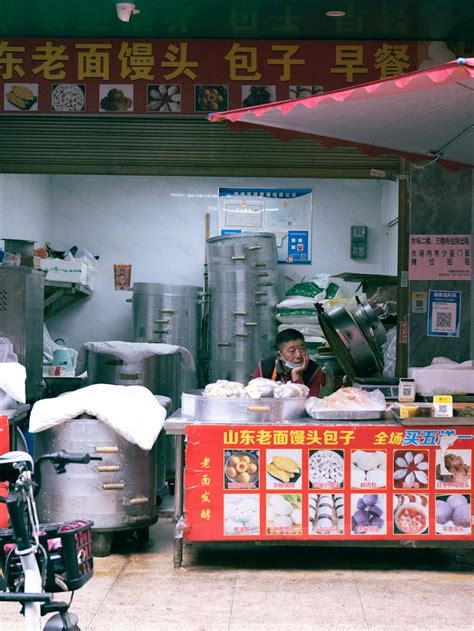 Street Food Stall next to Restaurant at Night · Free Stock Photo