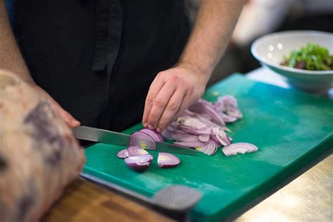 Chef hands cutting the onion with knife 12106739 Stock Photo at Vecteezy