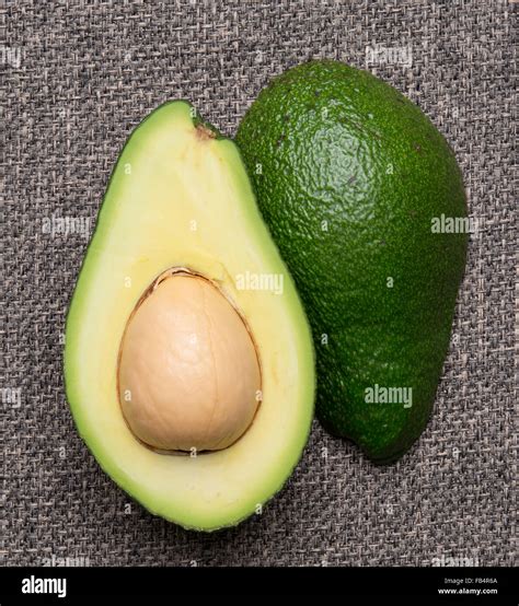 cut in half green avocado Stock Photo - Alamy