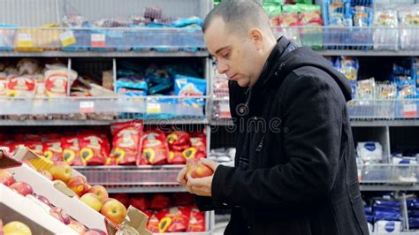 Man Carefully Picking Ripe, Red Apples from Grocery Store Produce ...