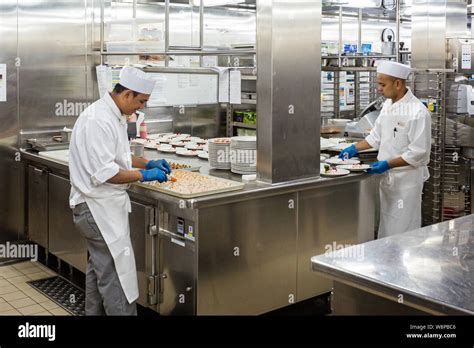 Behind the scenes view of food preparation in the kitchen, galley on ...