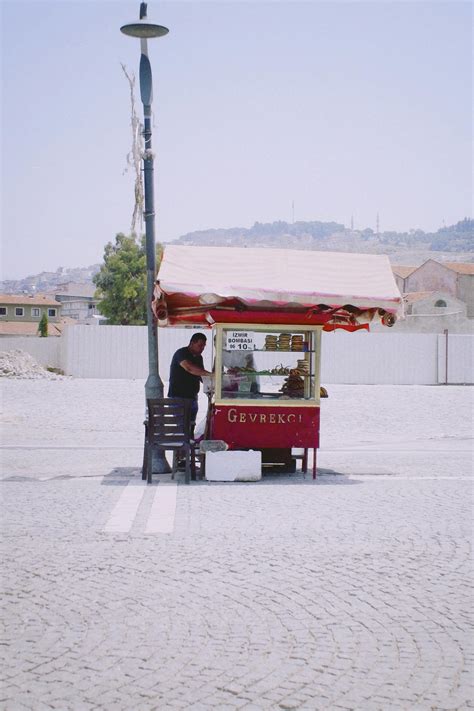 Street Food Stall next to Restaurant at Night · Free Stock Photo