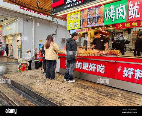 ShenZhen, China - March 05, 2025 : A food stall is bustling with ...