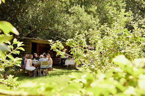 People eating a meal outdoors in summer in a garden - Stock Image ...