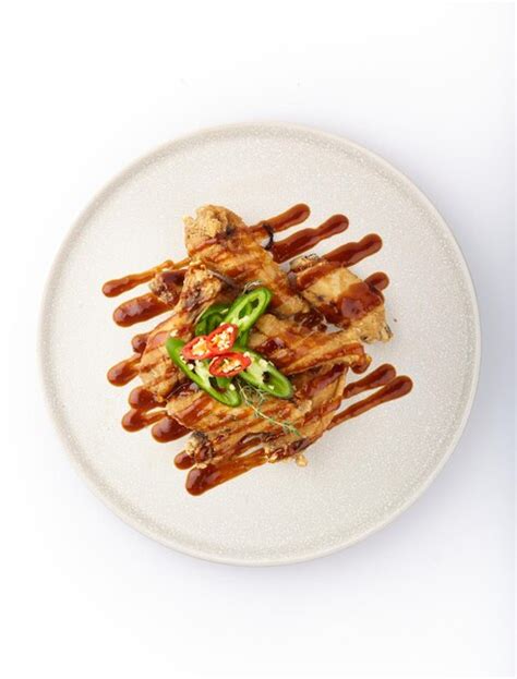 Premium Photo | Plate of food with sauce drizzle on top