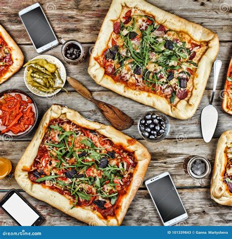 Appetizing Homemade Pizza on a Wooden Table. Friendly Feast at Home ...