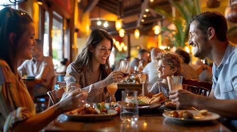 Happy family enjoying a meal together at a restaurant | Premium AI ...