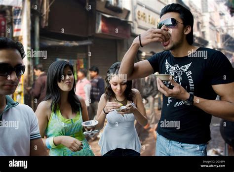 Friends enjoying street food Stock Photo - Alamy