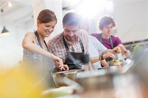 Couple enjoying cooking class kitchen - Stock Image - F016/7015 ...