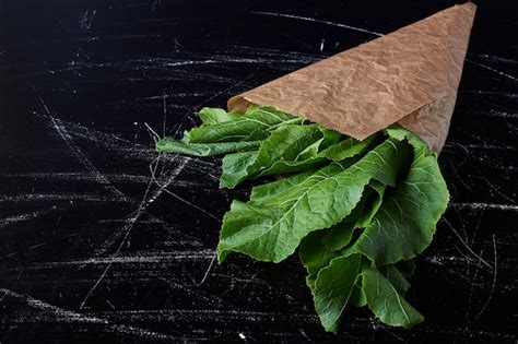 Free Photo | Green herbs in a paper wrap.