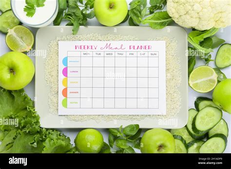 Plate with meal plan and healthy products on white background Stock ...