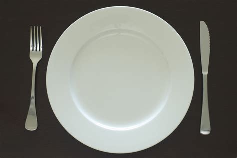 Plain white clean empty dinner plate and cutlery - Free Stock Image