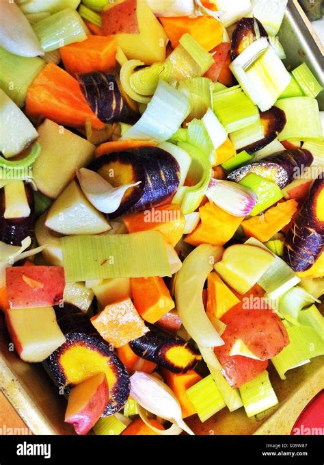Fresh organic farm grown chopped vegetables ready for roasting in the ...
