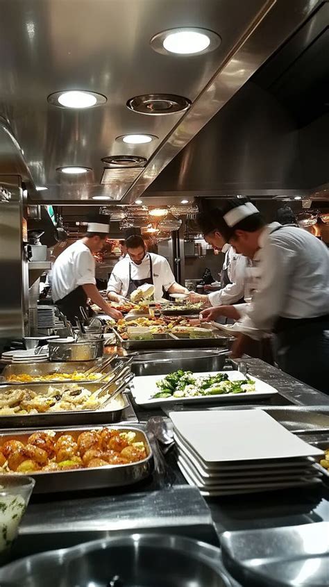 A Bustling Restaurant Kitchen with Chefs Plating Gourmet Meals Under ...