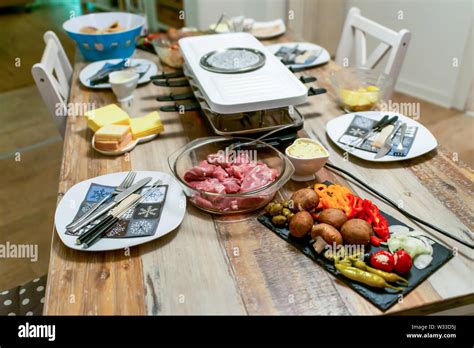 Swiss or Dutch raclette table filled with ingredients for a celebratory ...