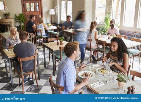 Customers Enjoying Meals in Busy Restaurant Stock Photo - Image of ...