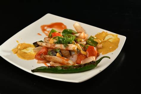 Premium Photo | A plate of food with a yellow sauce on it