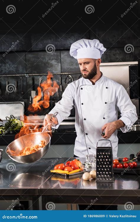 Chef Prepare Food with Fire at Kitchen Restaurant. Chef with Wok at ...