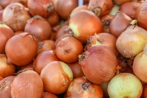 Premium Photo | Onions piled in a pile at the local market