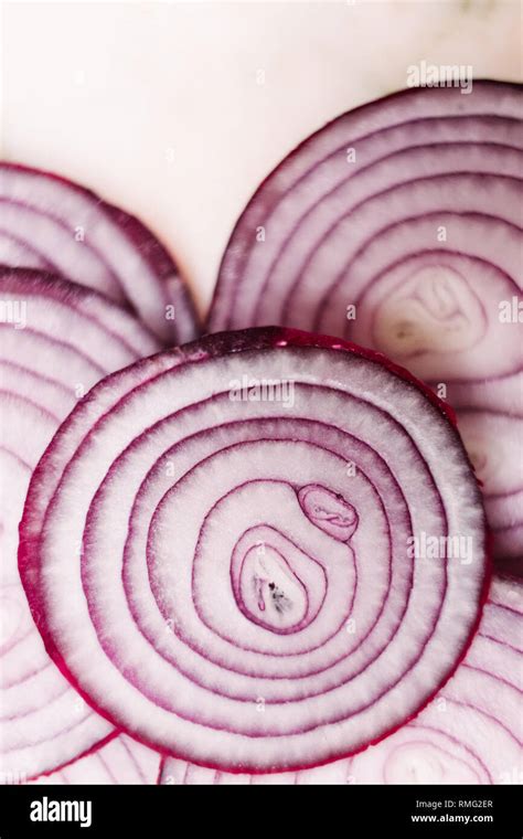 Slices of onion on tabletop Stock Photo - Alamy