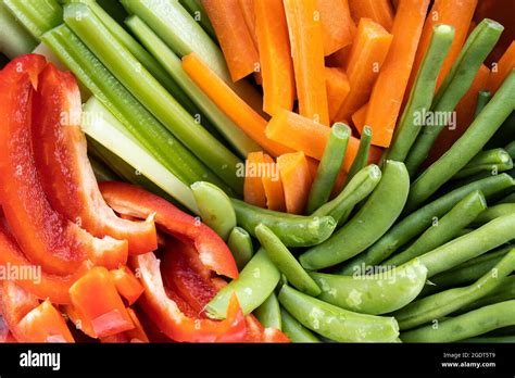 A close up rainbow of healthy fresh organic vegetables cut up into ...