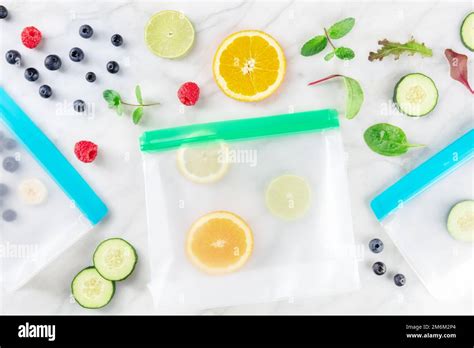 Food storage bags with fruit and vegetables, overhead flat lay shot ...