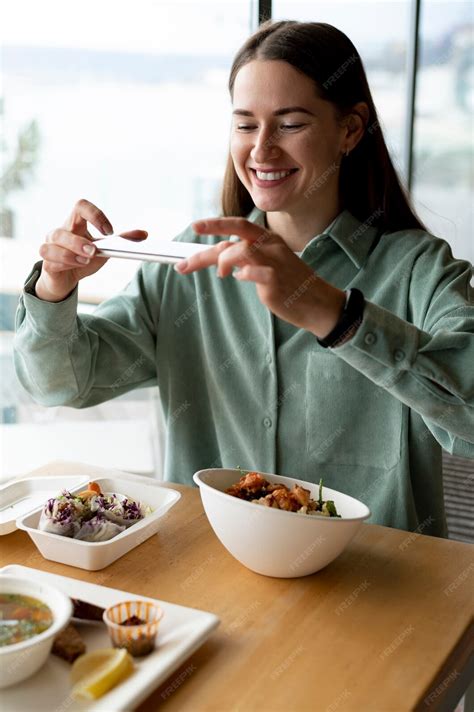 Free Photo | Foodie taking photo of a bowl with salad and a casserole ...