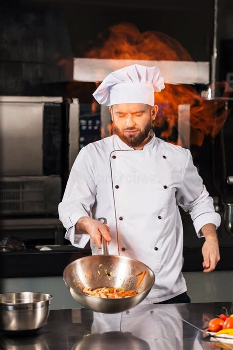 Chef Man Prepare Food At Kitchen. Chef Male Cook Asian Food With Fire ...