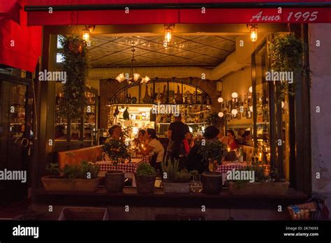 busy restaurant interior seen through the open window from outside ...