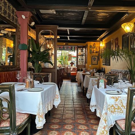 A local restaurant with a charming interior tables set for dining and a ...