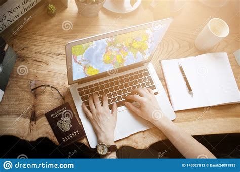 A Traveler Girl in a Cafe with a Laptop is Looking for Information on ...