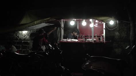 People waiting for their food at street food stall