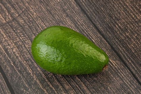 Premium Photo | Ripe green avocado over background