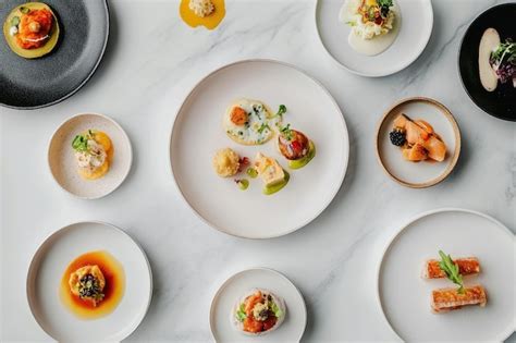 A beautifully arranged gourmet meal featuring various dishes on elegant ...